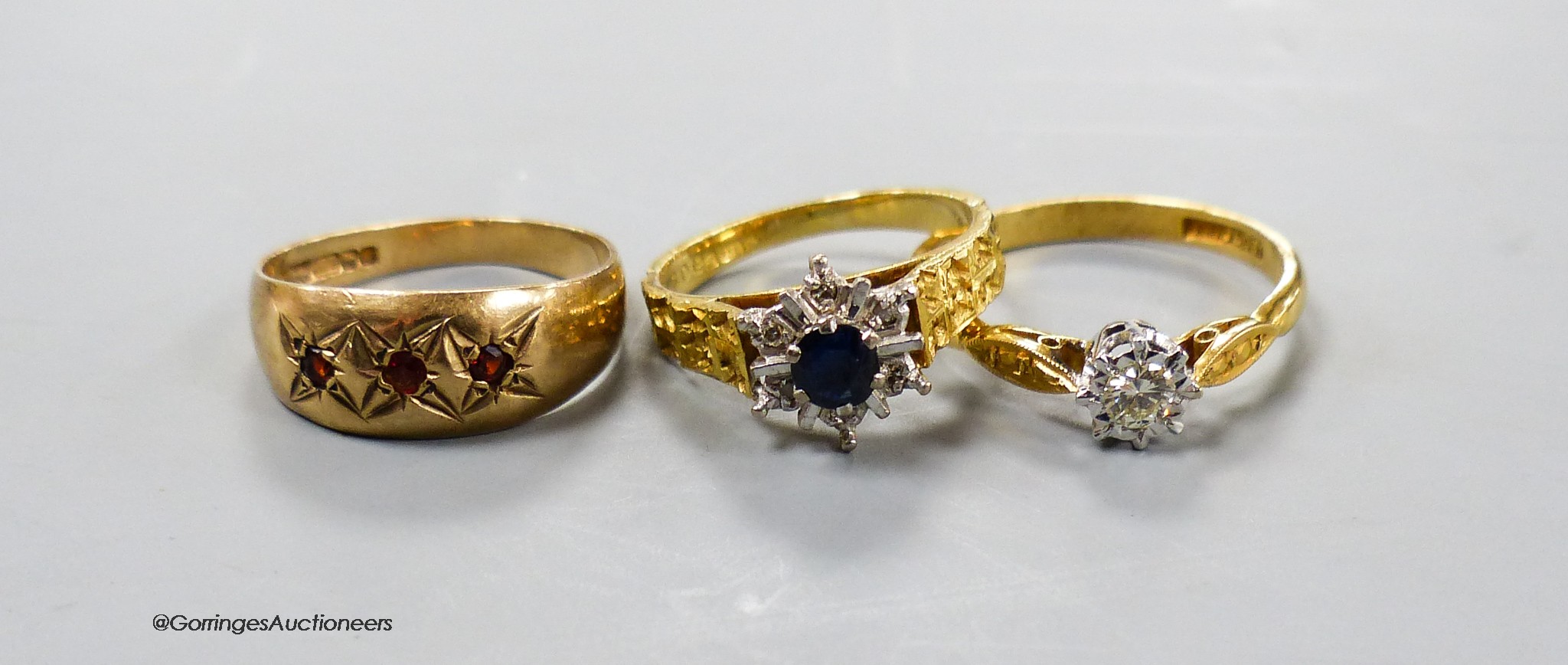 Two 18ct and gem set dress rings, gross 6.4 grams and a 9ct and gem set ring, gross 2.1 grams.